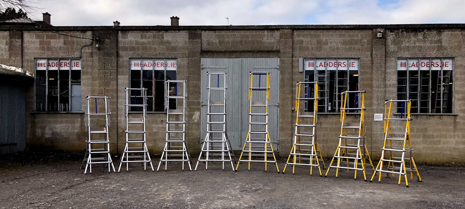 Height-adjustable podiums made from aluminium and fibreglass in various sizes, displayed in front of the Ladders.ie warehouse.