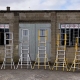 Height-adjustable podiums made from aluminium and fibreglass in various sizes, displayed in front of the Ladders.ie warehouse.